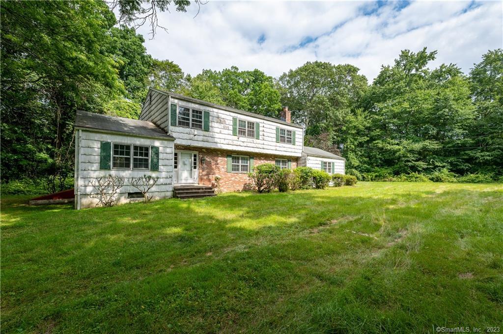 462 Taconic Road Stamford, CT 06831 - Photo 1 of 1 a front view of a house with a yard table and chairs