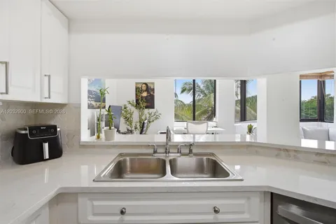 a kitchen with a sink and a stove next to a window
