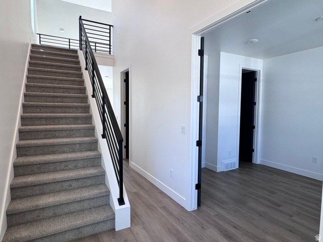 1301 1475 East, Unit 33 Payson, UT 84651 - Photo 2 of 10 Modern staircase with carpeted treads and contemporary black metal railings