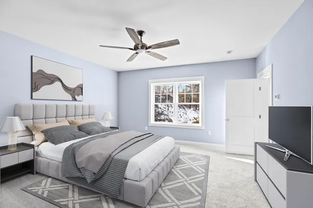 a bedroom with a bed and a tv on the dresser