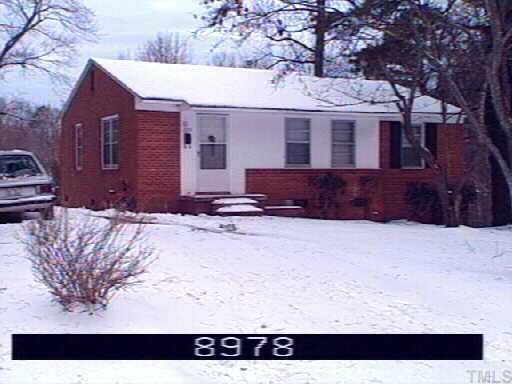 1229 Downing Road Raleigh, NC 27610 - Photo 1 of 1 a view of a house with a yard covered in snow