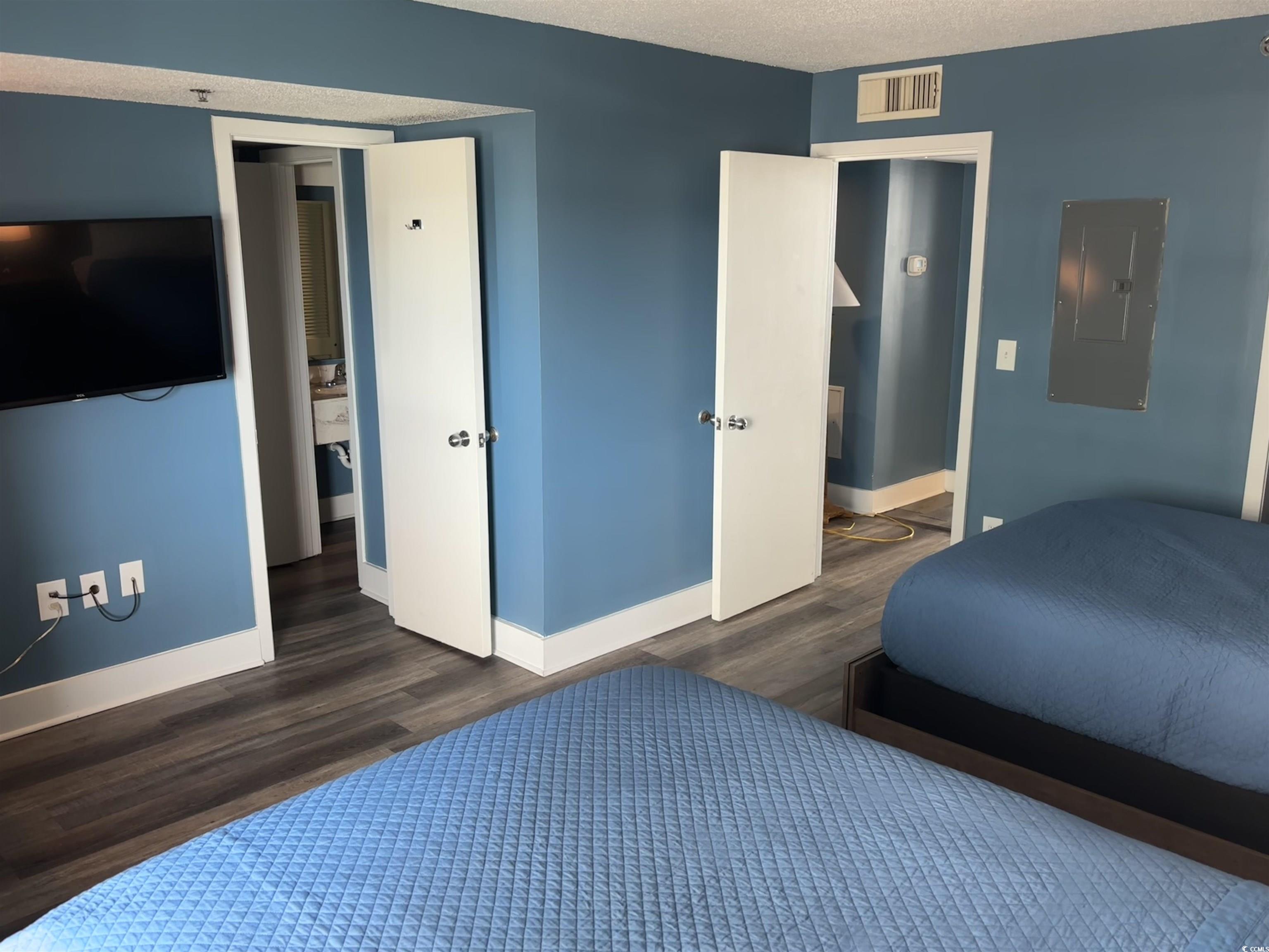 201N 74th Avenue North, Unit 2845/46 Myrtle Beach, SC 29572 - Photo 6 of 9 Bedroom featuring a textured ceiling, electric panel, and dark wood-style floors