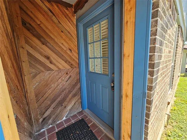 a view of a door and wooden floor