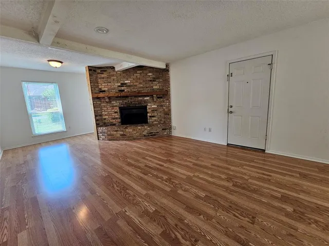 wooden floor fireplace and natural light in room