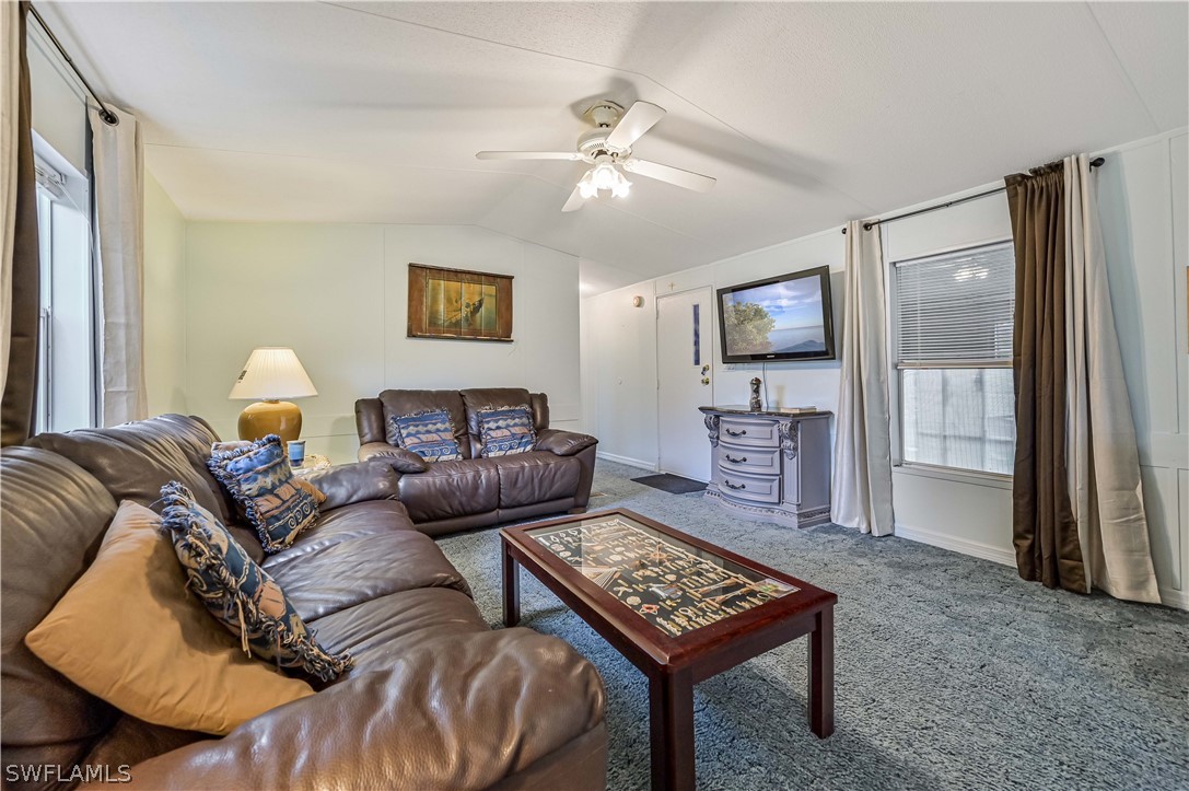 7461 Pinehurst Road Bokeelia, FL 33922 - Photo 13 of 25 a living room with furniture and a view of kitchen