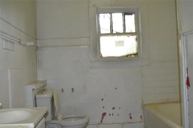 a bathroom with a bathtub and a window