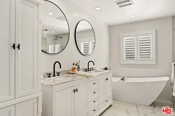 a bathroom with a bathtub and a sink