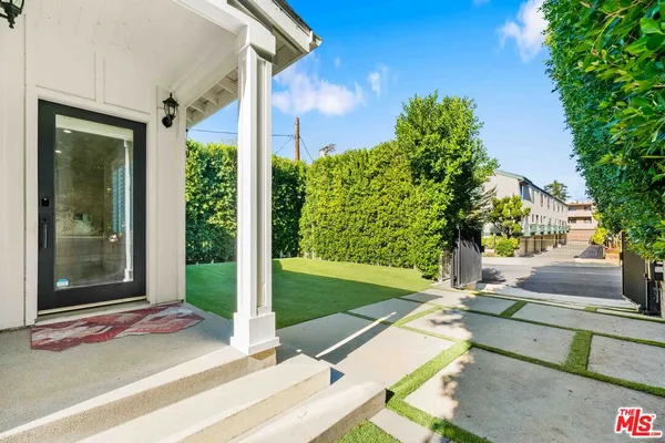a view of a porch with a floor to ceiling window and a yard