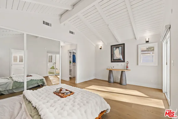 a bedroom with a bed and a table in it