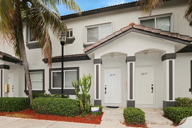 a view of a white house with a large windows