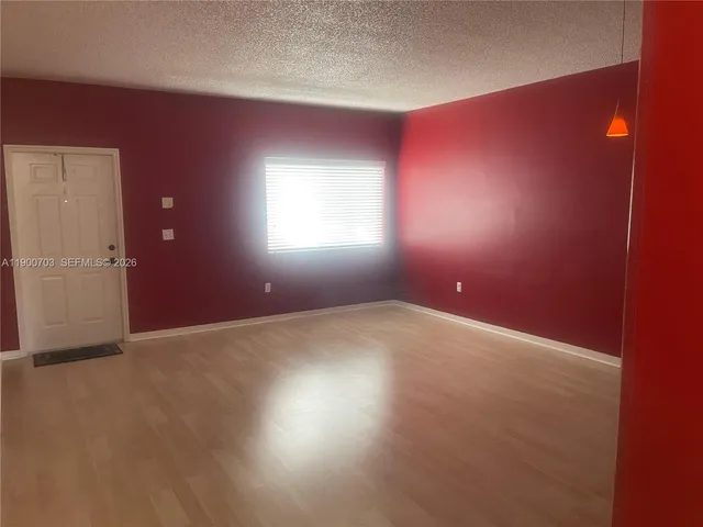 an empty room with windows and entrance