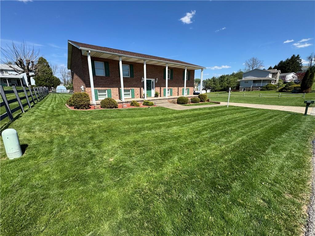a front view of a house with a yard table and chairs