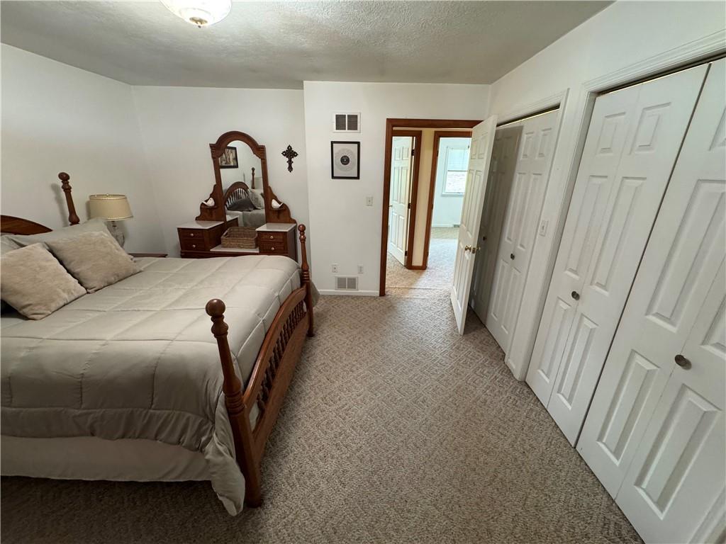 208 Pats Drive Rostraver Township, PA 15012 - Photo 11 of 50 a bedroom with a bed and a mirror