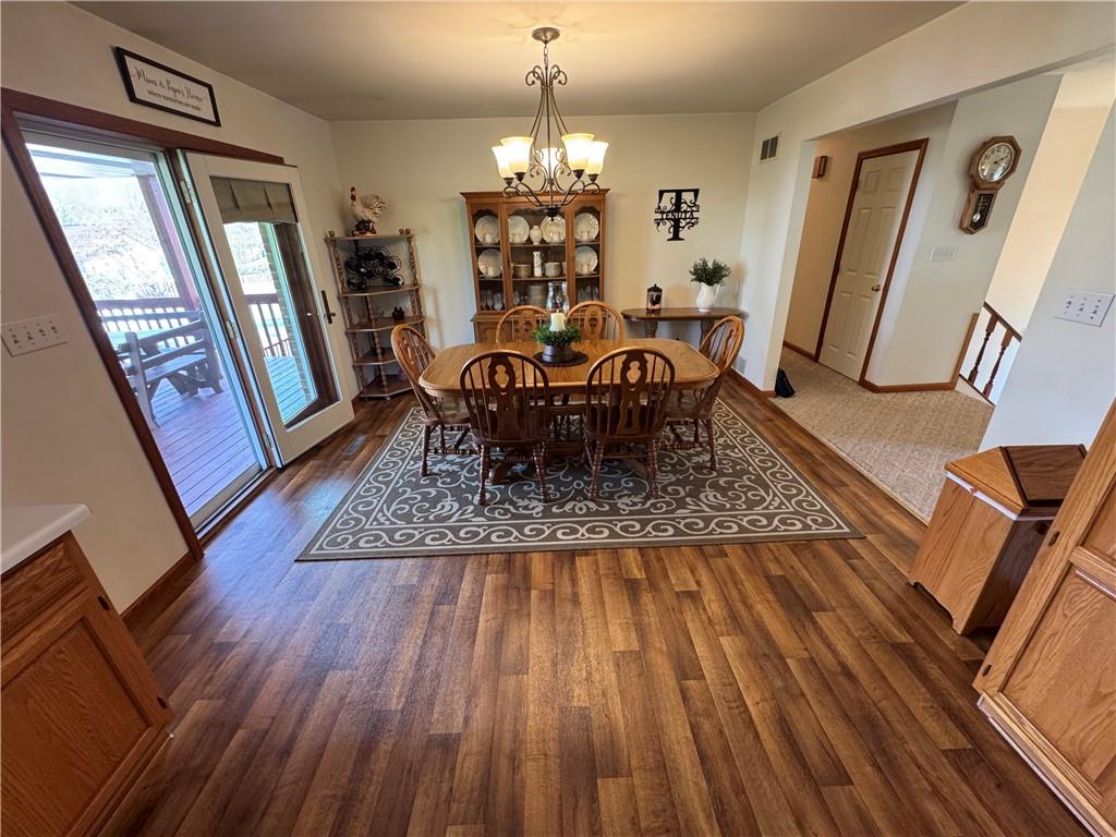 208 Pats Drive Rostraver Township, PA 15012 - Photo 24 of 50 a dining room with furniture a chandelier and wooden floor