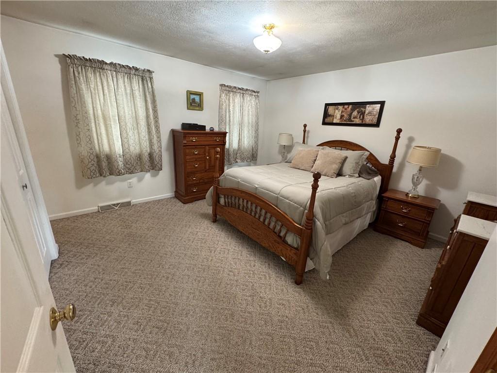 208 Pats Drive Rostraver Township, PA 15012 - Photo 8 of 50 a spacious bedroom with a bed and cabinet