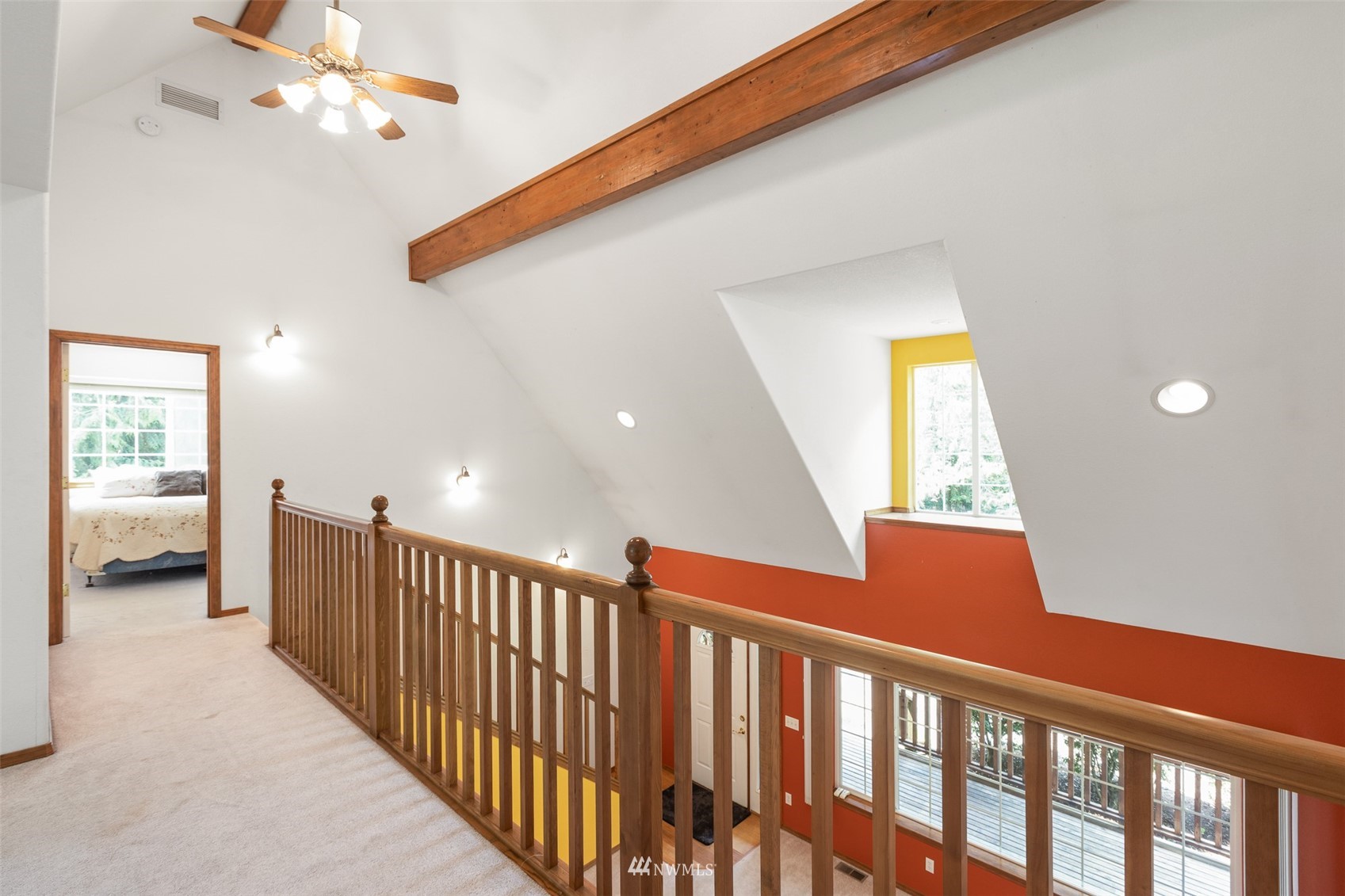 257 Riverside Road Sequim, WA 98382 - Photo 23 of 40 a view of a hallway with wooden floor and a ceiling fan