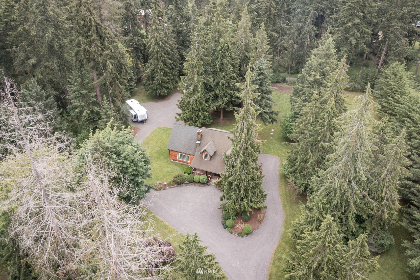 257 Riverside Road Sequim, WA 98382 - Photo 37 of 40 an aerial view of a house with a yard and trees all around