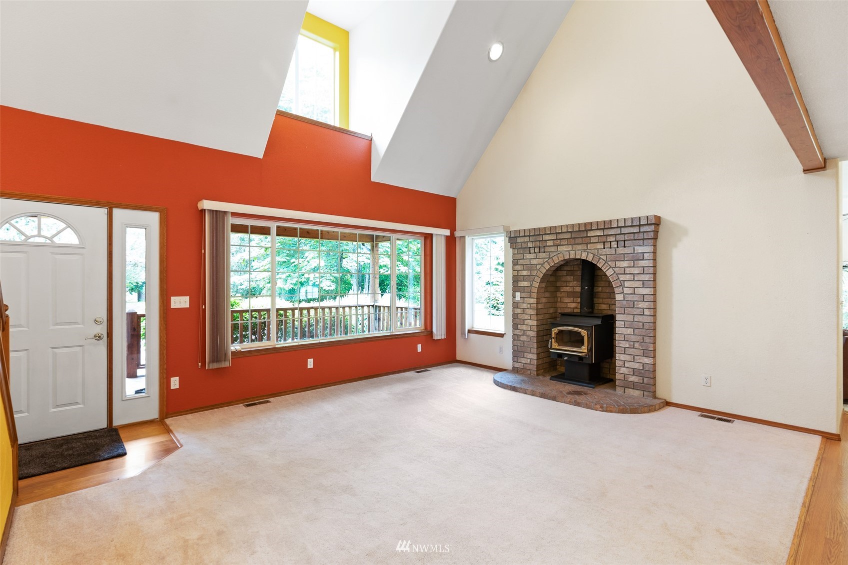257 Riverside Road Sequim, WA 98382 - Photo 4 of 40 an empty room with a fireplace and window