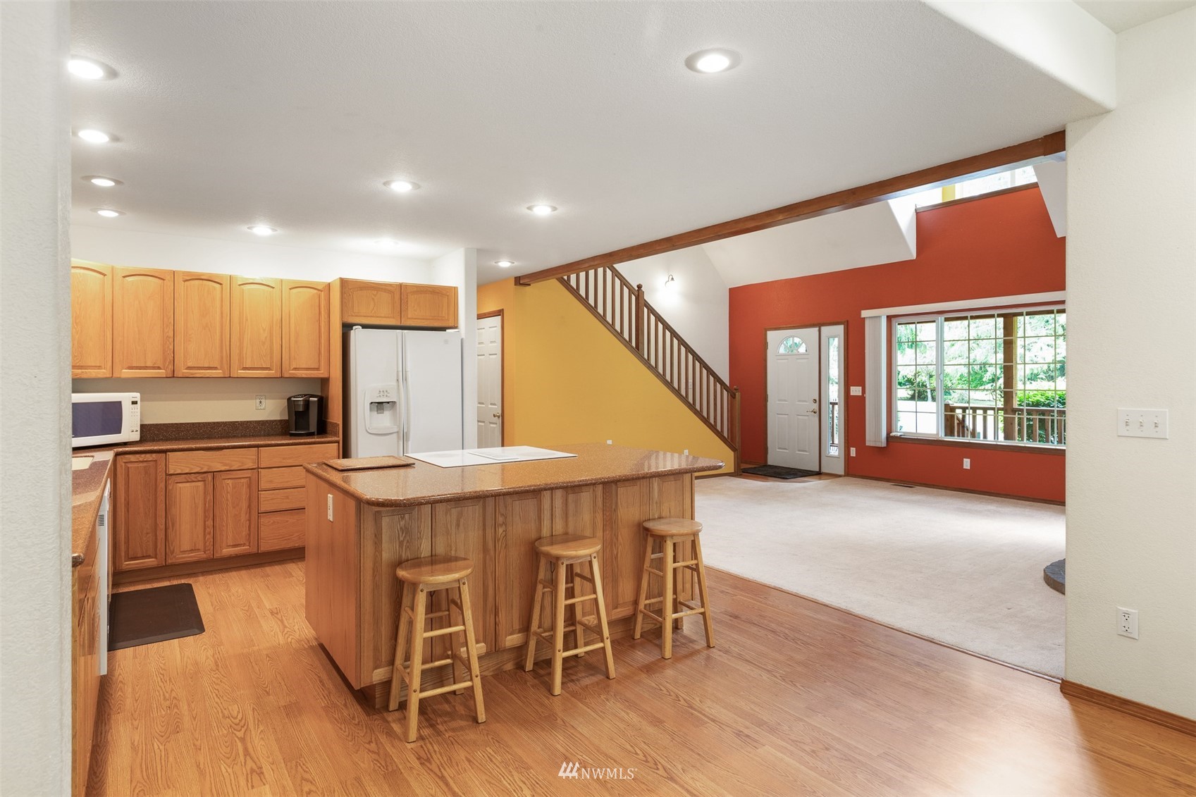 257 Riverside Road Sequim, WA 98382 - Photo 6 of 40 a kitchen with a table chairs refrigerator and microwave