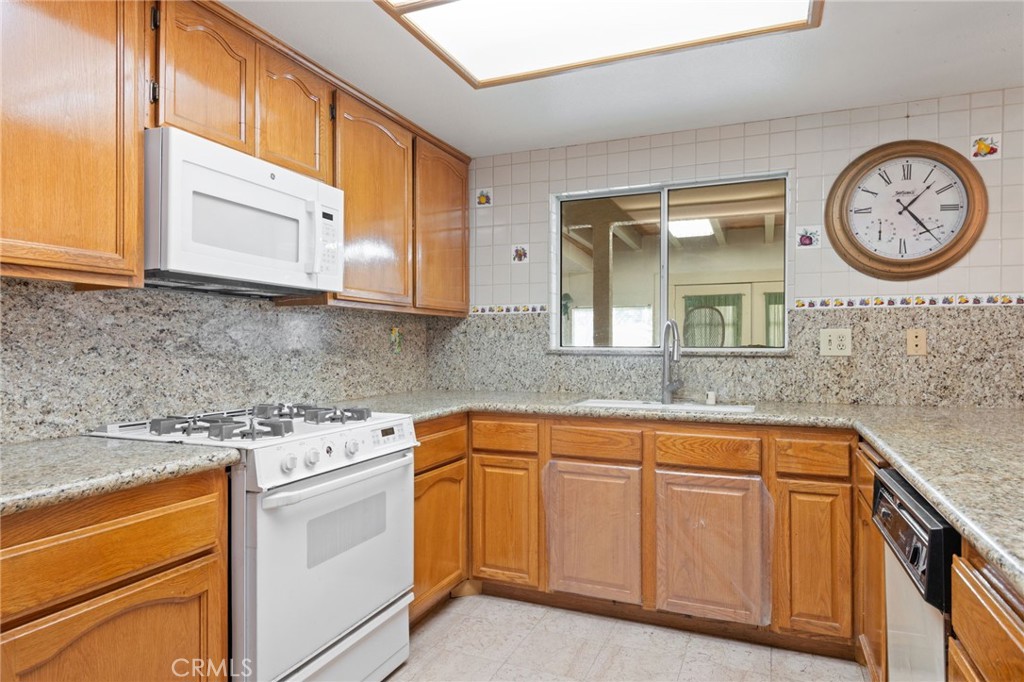 3047 Prado Lane Colton, CA 92324 - Photo 14 of 51 a kitchen with stainless steel appliances granite countertop a sink and a stove