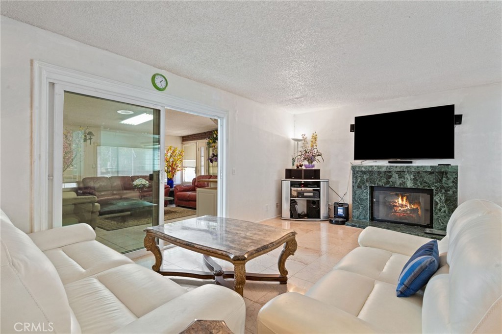 3047 Prado Lane Colton, CA 92324 - Photo 17 of 51 a living room with furniture a fireplace and a flat screen tv