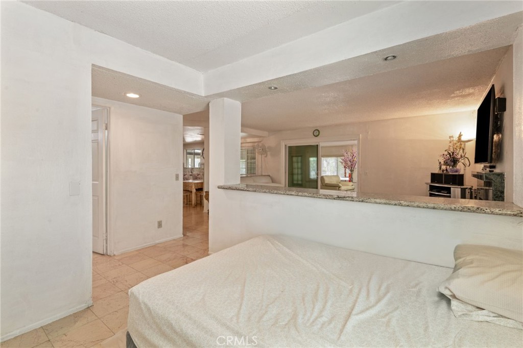 3047 Prado Lane Colton, CA 92324 - Photo 23 of 51 a bedroom with a bed and a large mirror