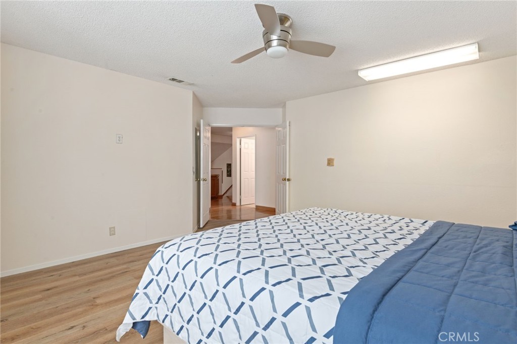 3047 Prado Lane Colton, CA 92324 - Photo 26 of 51 a bedroom with a bed and wooden floor