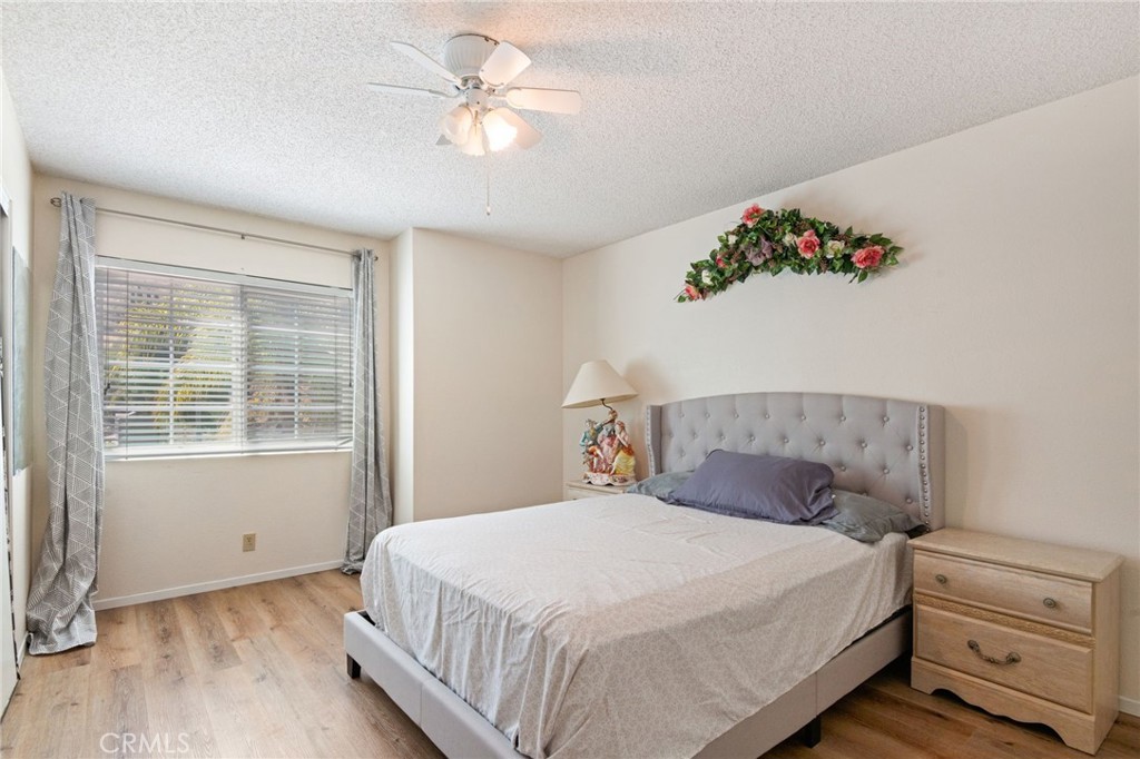 3047 Prado Lane Colton, CA 92324 - Photo 27 of 51 a bedroom with a large bed and a chandelier