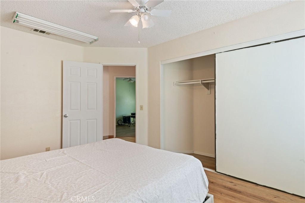 3047 Prado Lane Colton, CA 92324 - Photo 28 of 51 a bedroom with a bed and a chandelier