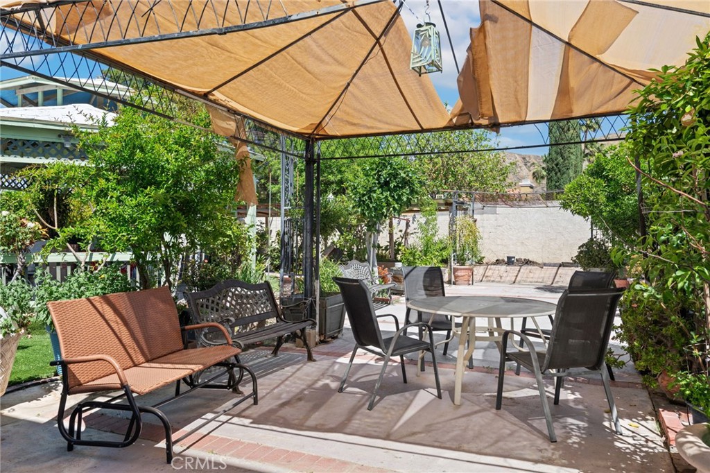 3047 Prado Lane Colton, CA 92324 - Photo 44 of 51 a view of a patio with table and chairs under an umbrella