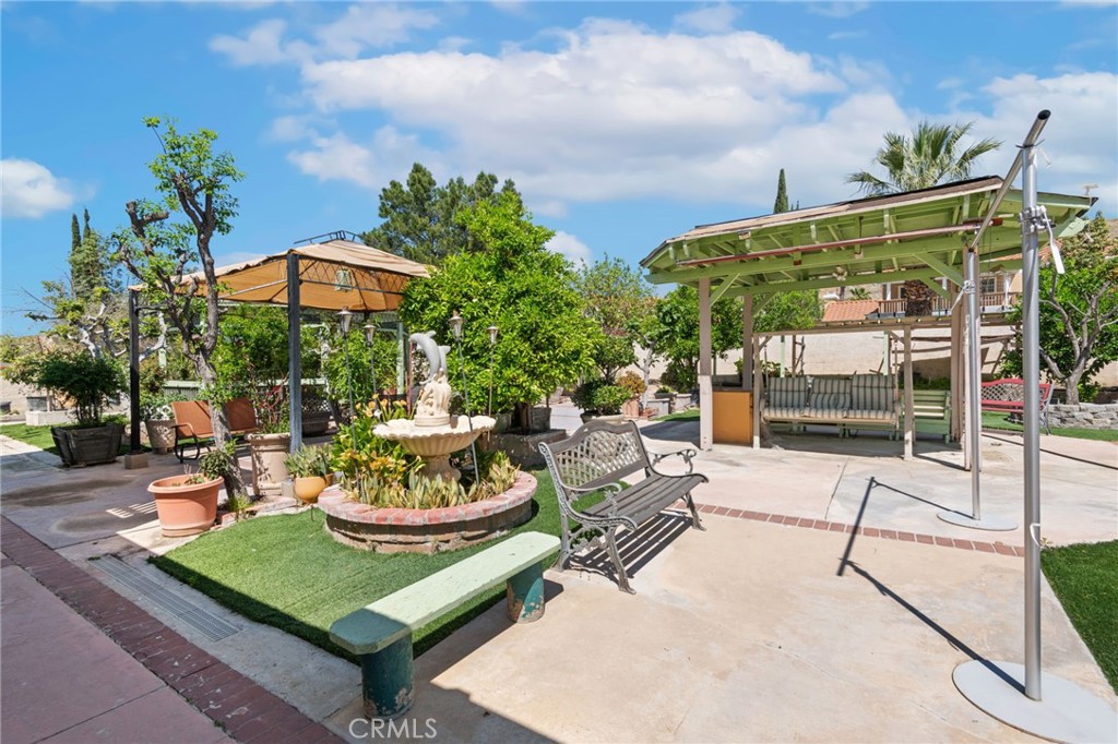 3047 Prado Lane Colton, CA 92324 - Photo 45 of 51 a view of a patio with a table and chairs under an umbrella