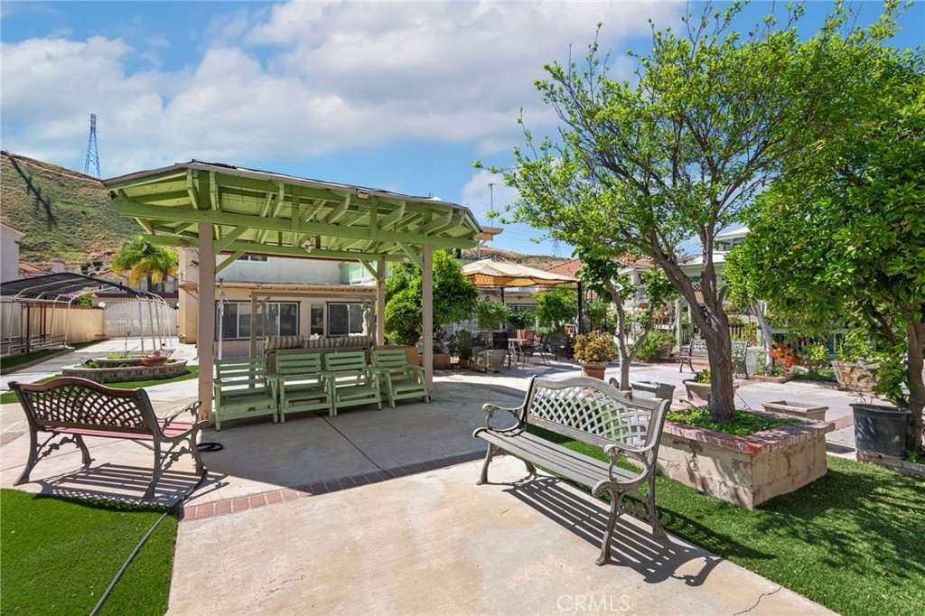 3047 Prado Lane Colton, CA 92324 - Photo 46 of 51 a view of a patio with a table and chairs under an umbrella