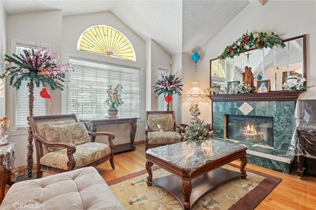 3047 Prado Lane Colton, CA 92324 - Photo 7 of 51 a living room with furniture a chandelier and a fireplace