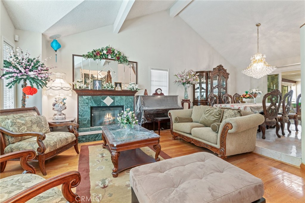 3047 Prado Lane Colton, CA 92324 - Photo 8 of 51 a living room with furniture a fireplace and a chandelier
