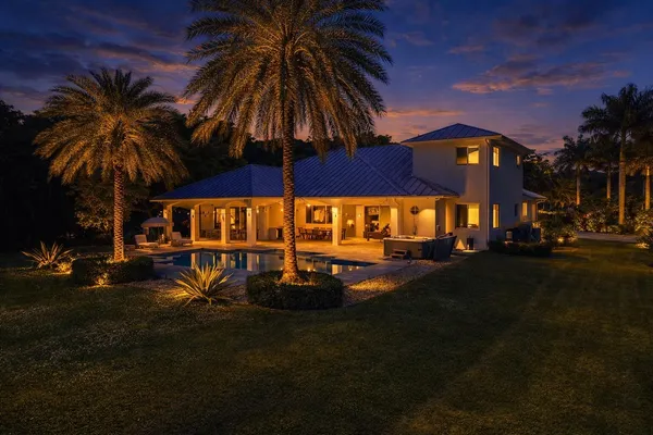 an aerial view of a house with a swimming pool yard and outdoor seating