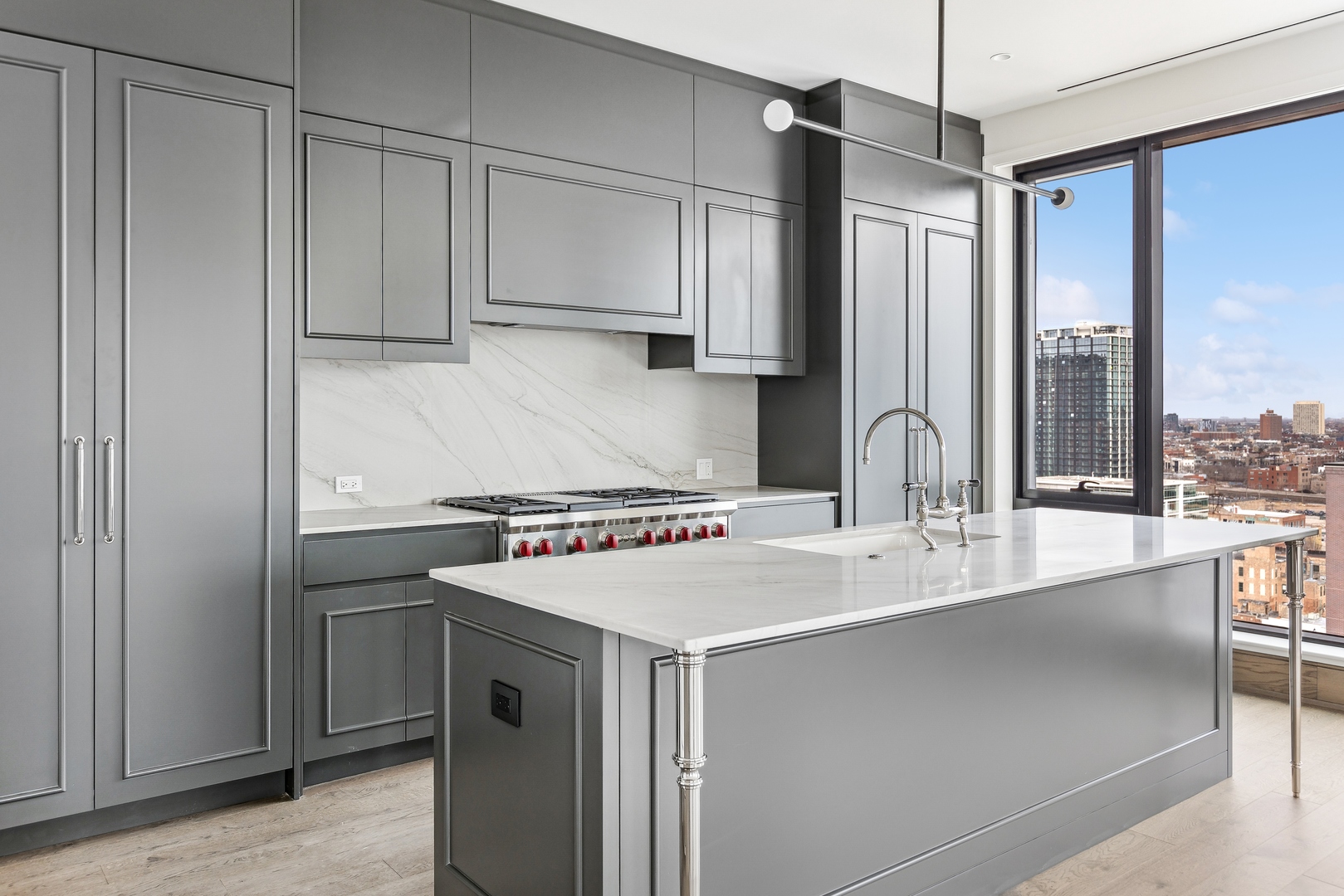 21 North May Street, Unit 1402 Chicago, IL 60607 - Photo 22 of 49 a kitchen with stainless steel appliances granite countertop a sink a stove and a refrigerator with wooden floor