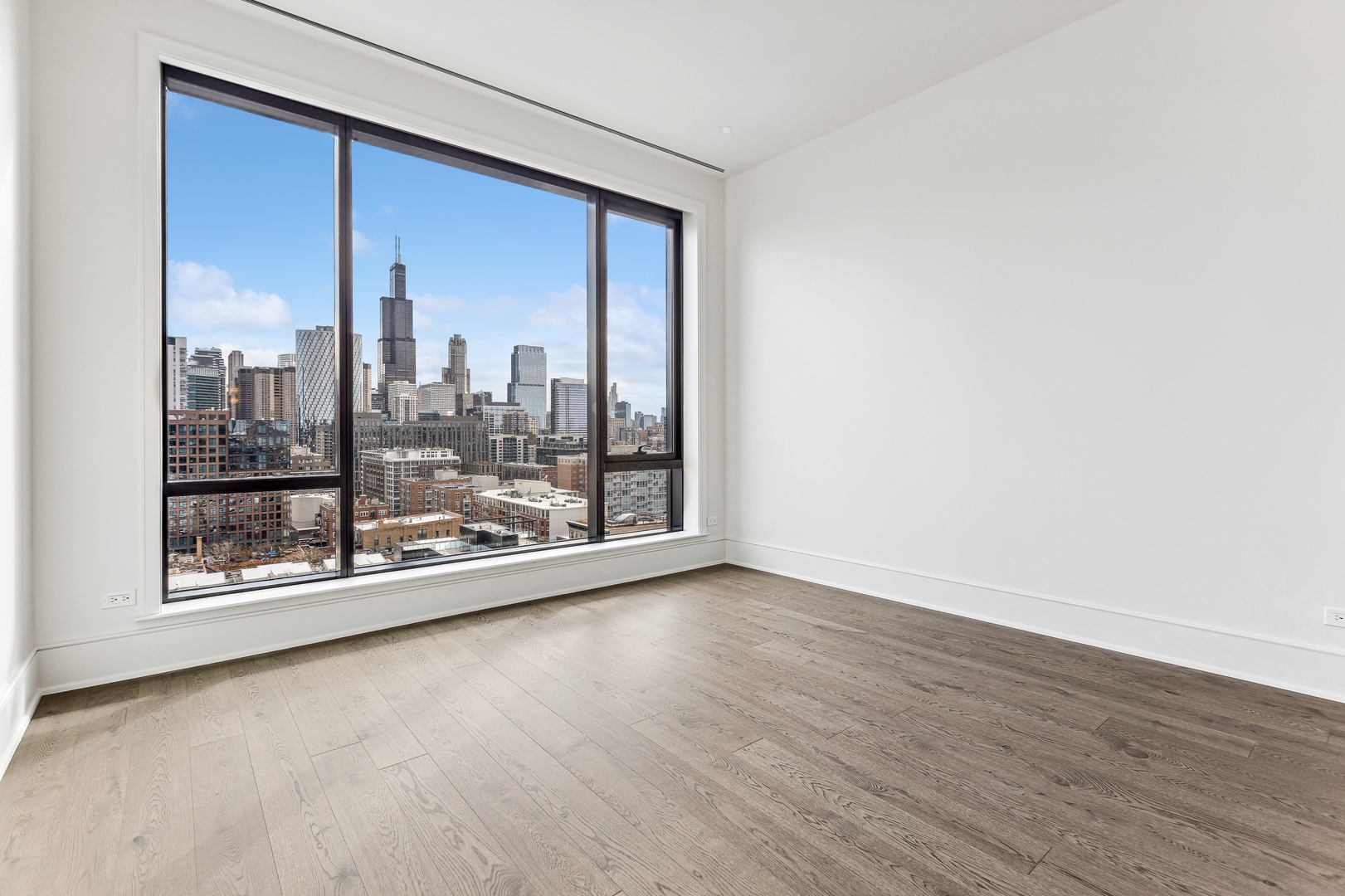 21 North May Street, Unit 1402 Chicago, IL 60607 - Photo 28 of 49 a view of a big room with wooden floor and windows