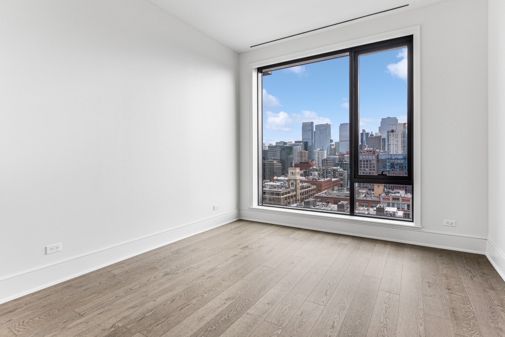 21 North May Street, Unit 1402 Chicago, IL 60607 - Photo 36 of 49 an empty room with wooden floor and doors