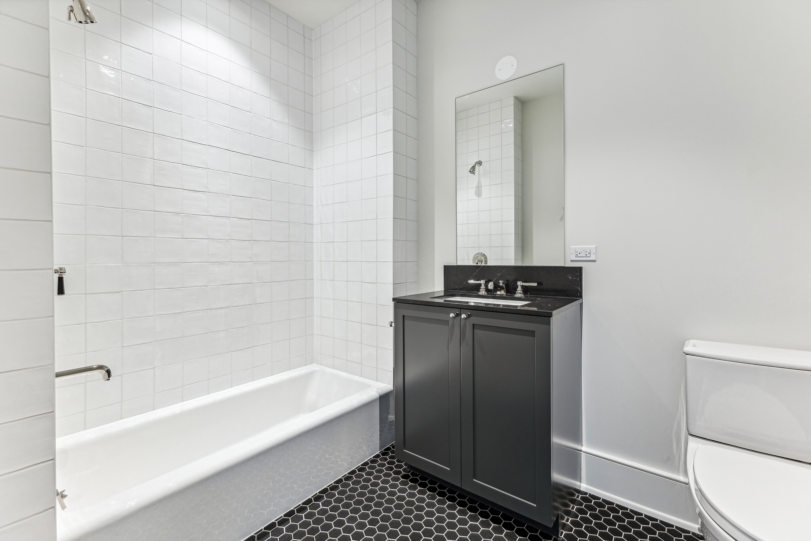 21 North May Street, Unit 1402 Chicago, IL 60607 - Photo 37 of 49 a bathroom with a bathtub and a shower