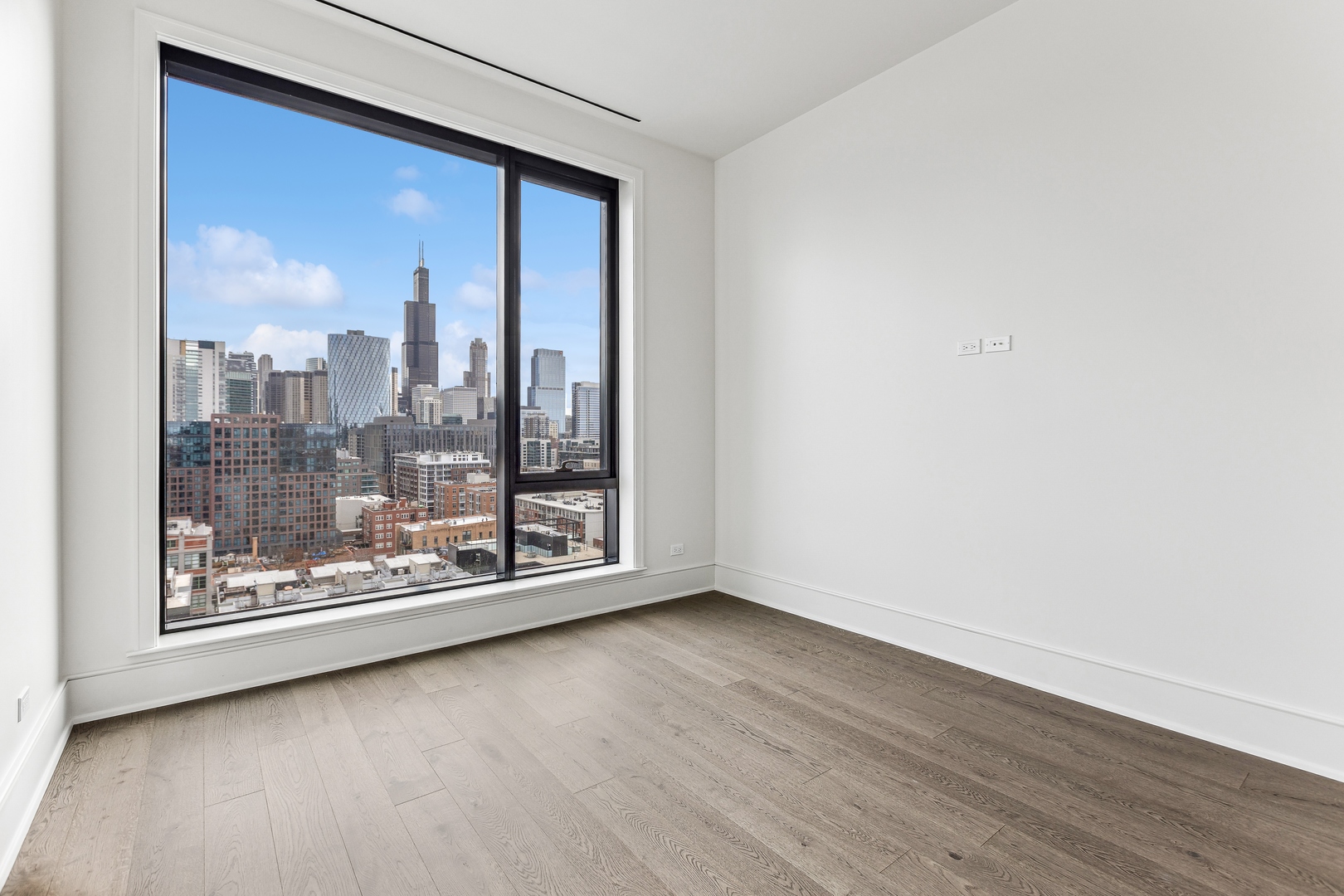 21 North May Street, Unit 1402 Chicago, IL 60607 - Photo 39 of 49 a view of a room with wooden floor and a large window with outer view