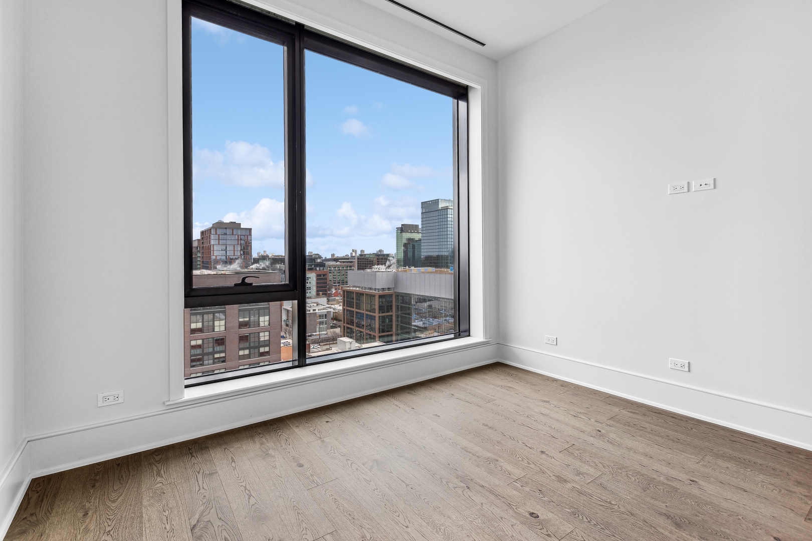 21 North May Street, Unit 1402 Chicago, IL 60607 - Photo 41 of 49 an empty room with wooden floor and windows