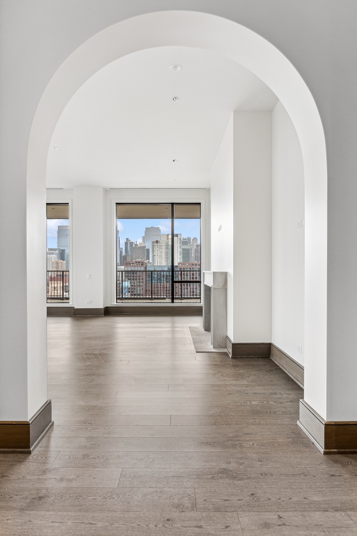 21 North May Street, Unit 1402 Chicago, IL 60607 - Photo 6 of 49 wooden floor in an empty room with a window