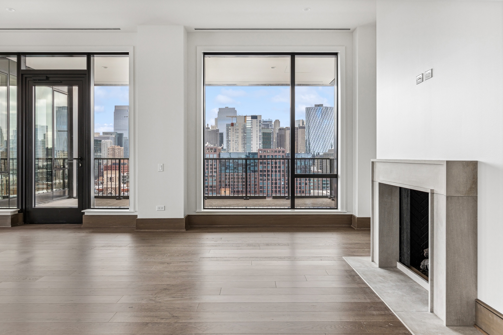 21 North May Street, Unit 1402 Chicago, IL 60607 - Photo 8 of 49 a view of an entryway with wooden floor and a fireplace