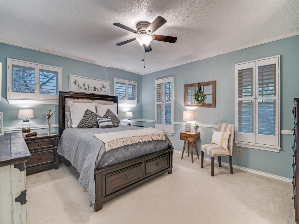 343 East Tripp Road Sunnyvale, TX 75182 - Photo 23 of 36 a bedroom with a bed and a chandelier