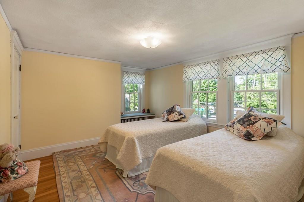 2 Highland Avenue Lexington, MA 02421 - Photo 24 of 32 a bedroom with a bed and wooden floor