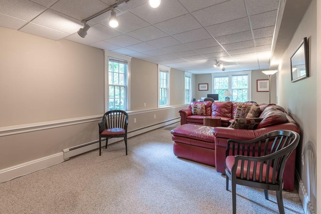 2 Highland Avenue Lexington, MA 02421 - Photo 25 of 32 a living room with furniture a ceiling fan and a window