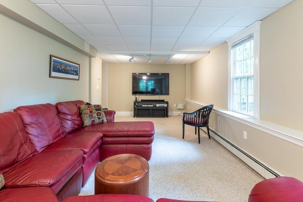 2 Highland Avenue Lexington, MA 02421 - Photo 28 of 32 a living room with furniture a flat screen tv and a large window