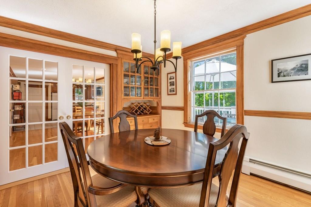 2 Highland Avenue Lexington, MA 02421 - Photo 9 of 32 a dining room with furniture a chandelier and wooden floor