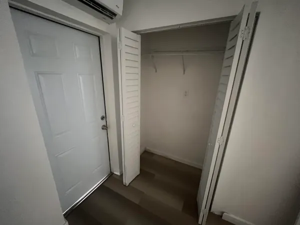 a bathroom with a sink a toilet a mirror and shower
