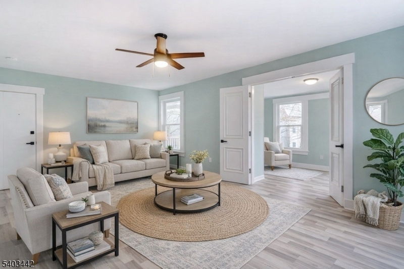 a living room with furniture and a wooden floor